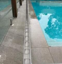 Custom pool overflow drainage completed for a happy customer.